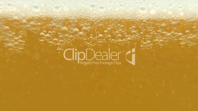 Pouring cold beer into glass