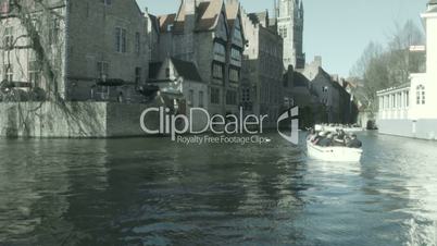 Boats on the river with people. Bruges, Belgium.