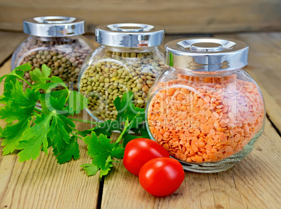 Lentils different in jars with parsley on board