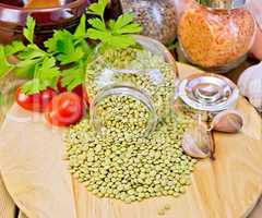 Lentils green in jar with parsley on board