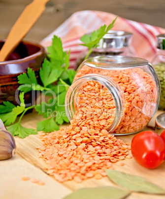 Lentils red in jar with parsley on board