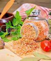 Lentils red in jar with parsley on board