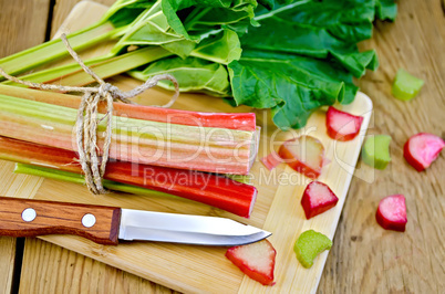 Rhubarb cut with a leaf on board