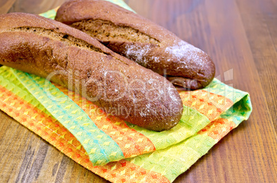 Rye baguettes on a napkin and board