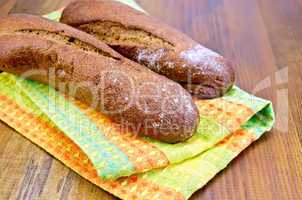 Rye baguettes on a napkin and board