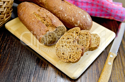 Rye baguettes with a knife and basket on board