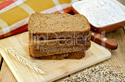 Rye bread with flour and grain on board