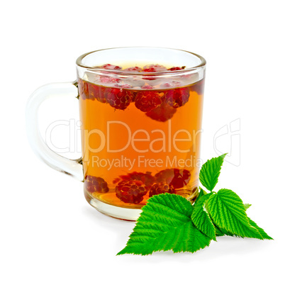 Tea with raspberry and green leaf in glass mug