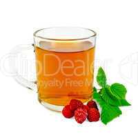 Tea with raspberry in glass mug