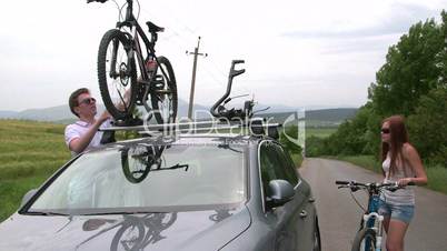 Cyclists traveling with two bikes on the roof of car