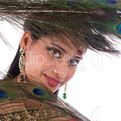 Indian girl with peacock feathers.