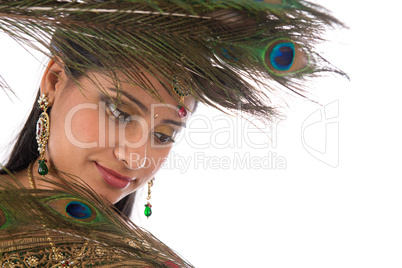 Indian female with peacock feathers.