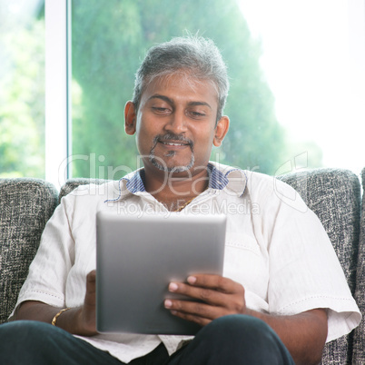 Indian man using digital tablet computer