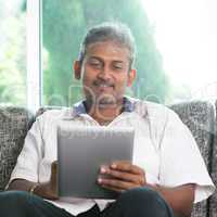 Indian man using digital tablet computer