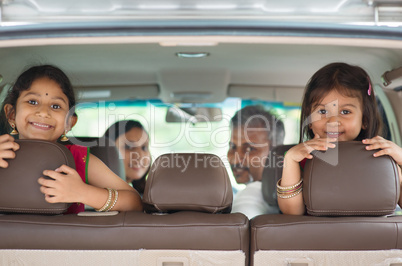 Indian family sitting in car