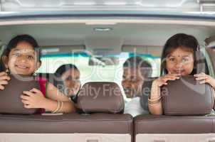 Indian family sitting in car