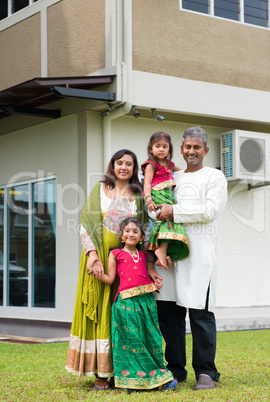 Family standing outside their new house.