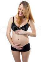 Pregnant woman with tummy laughing