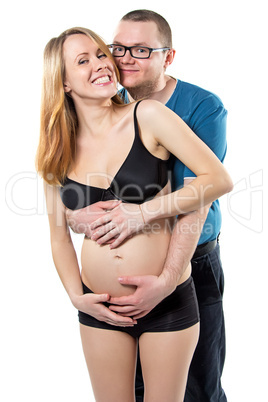 Pregnant wife and her happy husband laughing