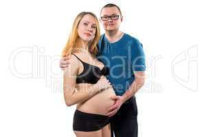 Pregnant wife and her happy husband standing
