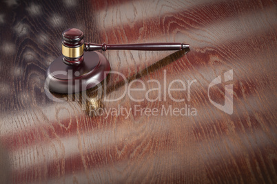 Wooden Gavel Resting on Flag Reflecting Table