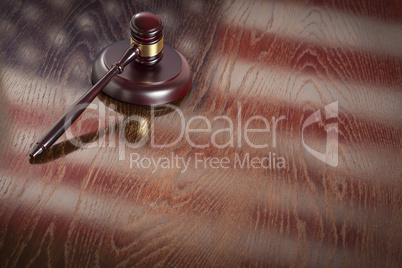 Wooden Gavel Resting on Flag Reflecting Table