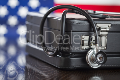 Briefcase and Stethoscope Resting on Table with American Flag Be