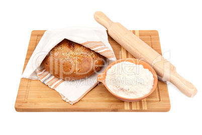 bread and kitchen utensils on a white background