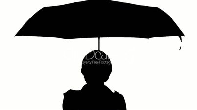 Black and white image of a woman with umbrella.