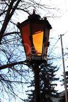 Retro street lamp shining at the twilight