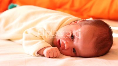 Newborn Laying in Bed