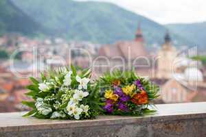 Wedding bouquet spring flowers with panoramic Brasov city view