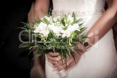 Bride with groom holding a wedding bouquet