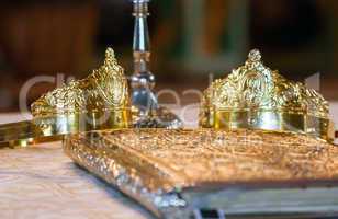 Wedding crowns and bible prepared for ceremony
