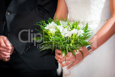 Bride with groom holding a wedding bouquet