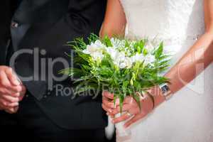 Bride with groom holding a wedding bouquet