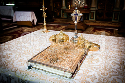 Wedding crowns and bible prepared for ceremony