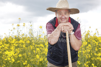 Man with straw hat in rape field