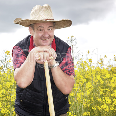 Man with straw hat in rape field