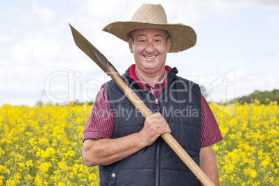 Man with straw hat in rape field