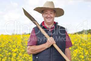 Man with straw hat in rape field