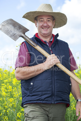 Man with straw hat in rape field