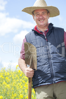 Man with straw hat in rape field