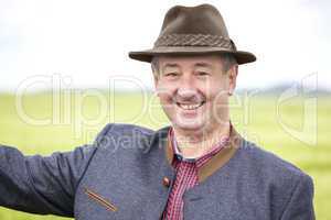 Man with hat pointing in the corn field