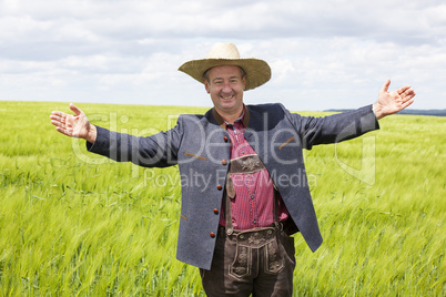 Man with hat pointing in the corn field