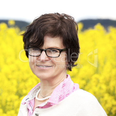 Farmer on flowering canola field