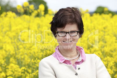 Farmer on flowering canola field