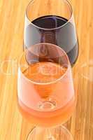 Glasses of Red and Pink Wine on Wooden Table