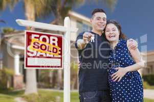 Hispanic Couple, Keys, New Home and Sold Real Estate Sign