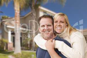 Happy Couple Hugging in Front of House
